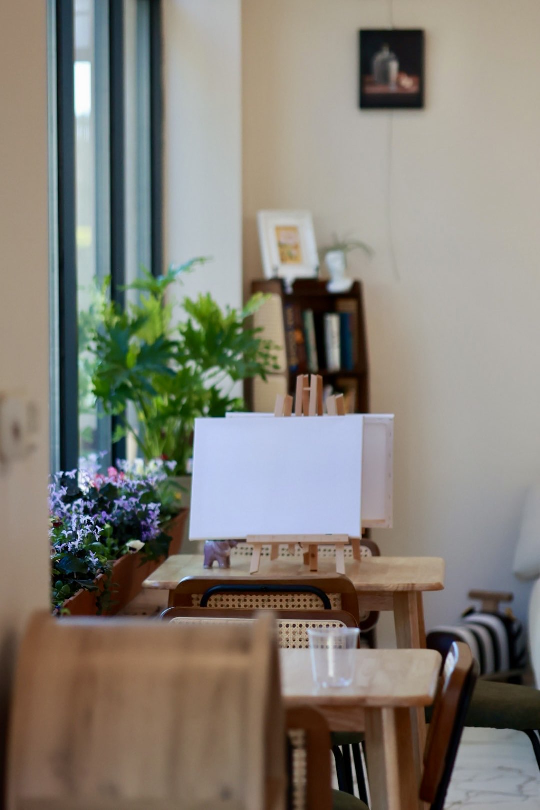 Blank canvases and easels arranged inside Muse & Co